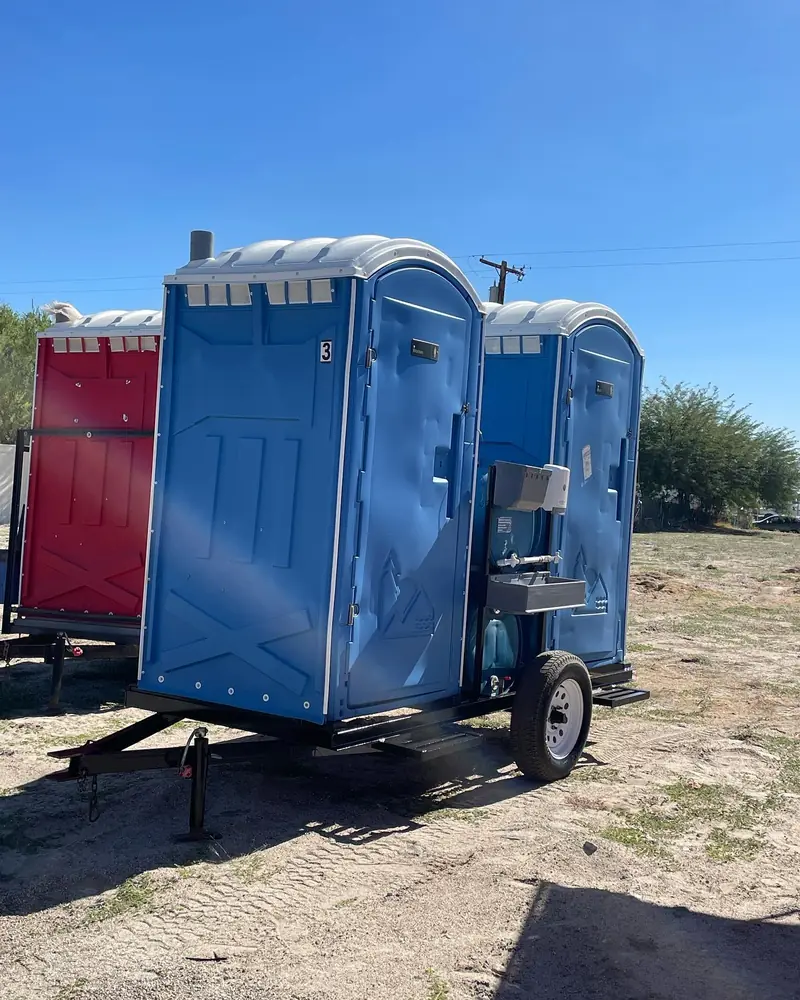 Portable toilets mounted on a towable trailer for moving between job-site phases